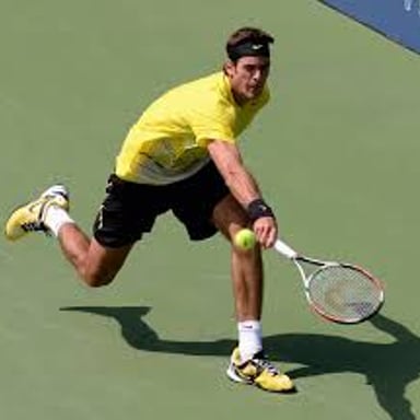 A tennis player hitting a high-arcing shot over an opponent.