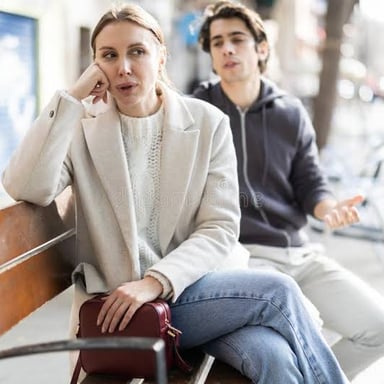 One person stopping another to speak on a street.