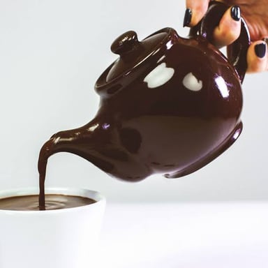 A teapot made of chocolate illustrating why it would be impractical to use for hot tea.