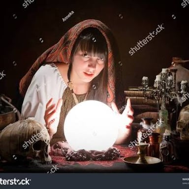 A fortune teller looking at a crystal ball.