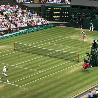 Tennis players competing in a Wimbledon final on Centre Court.