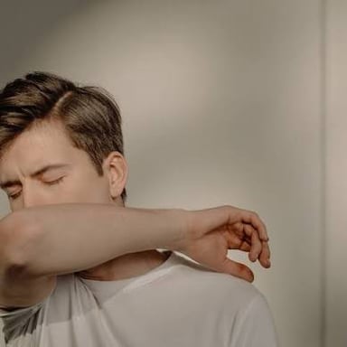 A person clearing their throat before speaking