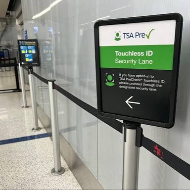 Signage identifying a TSA PreCheck lane at an airport security checkpoint.
