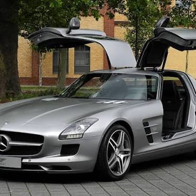 A Mercedes-Benz SLS AMG sports car with its distinctive gullwing doors.