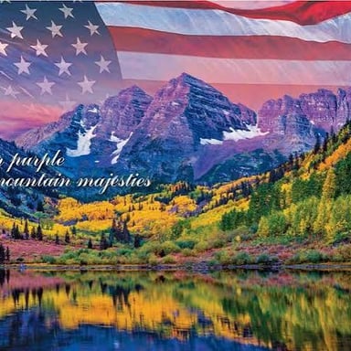 An American flag displayed against an expansive landscape