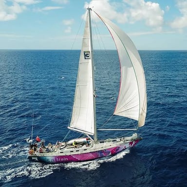 A sailboat traveling across open ocean water.