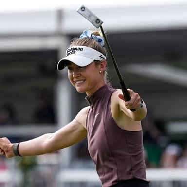 Women professional golfers competing on a golf course.