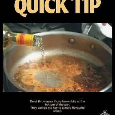 Browned cooking residue being loosened from a pan with liquid to make a sauce.