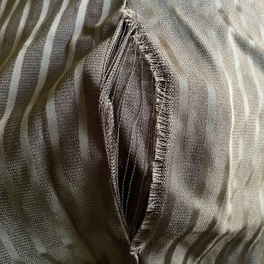 A close-up view of a tear in fabric.