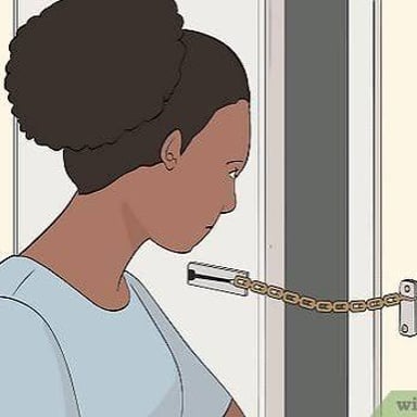 A person at a doorway responding to someone who has knocked.