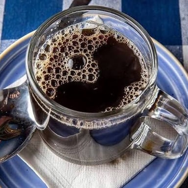 A cup of dark brewed coffee.