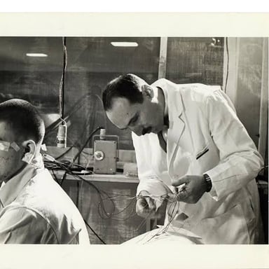 A person stimulating a reaction in a laboratory experiment