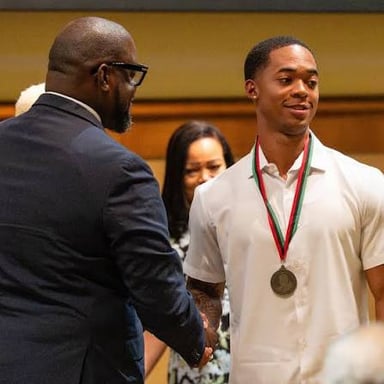 An honoree being recognized at an award ceremony.