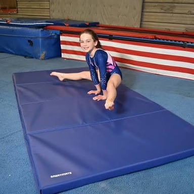 A padded exercise mat laid out for floor exercises.