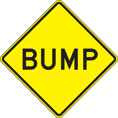 A roadside warning sign displaying the word BUMP