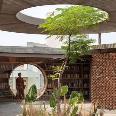 Daylight falls into a building atrium, an open central space surrounded by rooms or walkways.