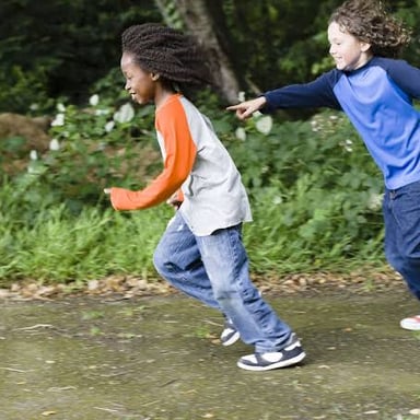Children running as they play a game of tag.