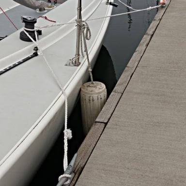 A boat secured alongside a harbor dock.