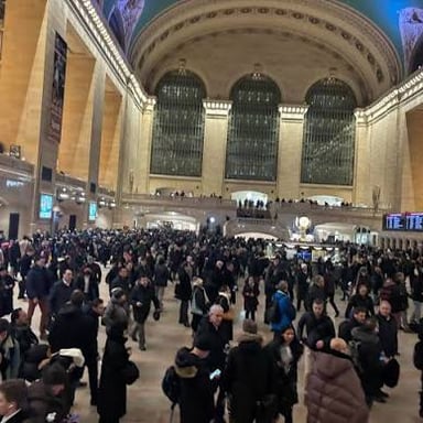 A large crowd arriving at a train station.