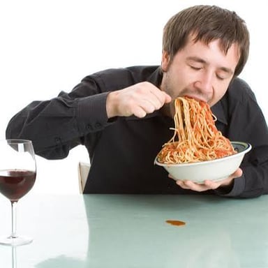 A person eating food quickly.