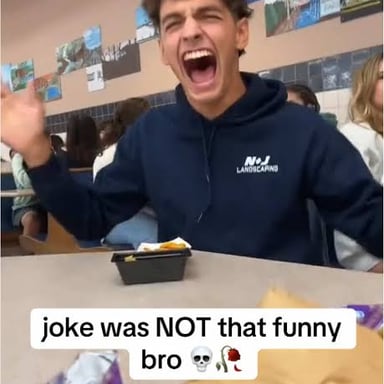 A student joking in a classroom, illustrating the phrase “crack wise.”