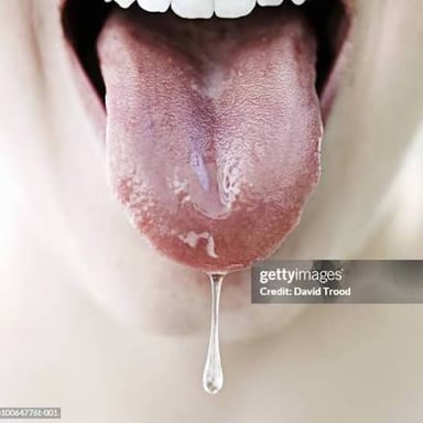 A person drooling, illustrating the release of saliva from the mouth.