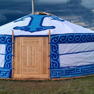 A traditional round Mongolian ger, with felt covering over its wooden frame.