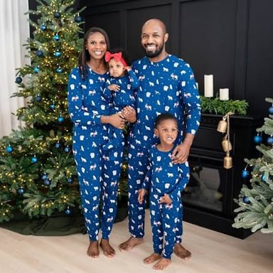 A family wearing coordinated pajamas for a group photo.