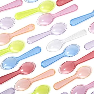 A small spoonful of food being offered for someone to taste.