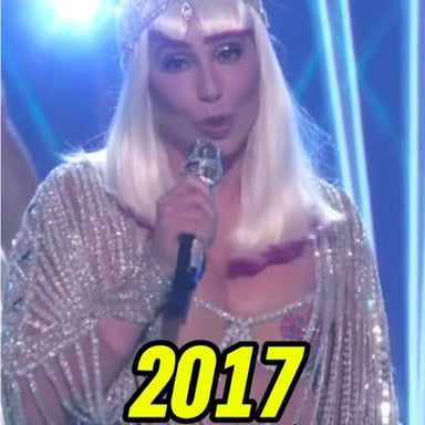 Singer Cher performing onstage, associated with her hit song “Believe.”
