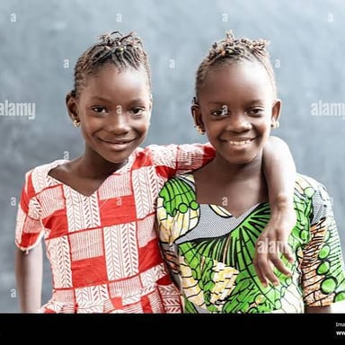 Two sisters smiling together.
