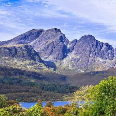The Cuillin mountains rising over the landscape of the Isle of Skye in Scotland.