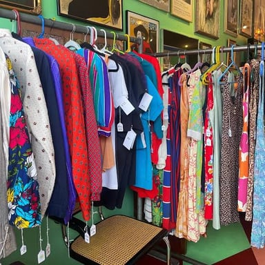 Vintage garments displayed for resale in a clothing shop.