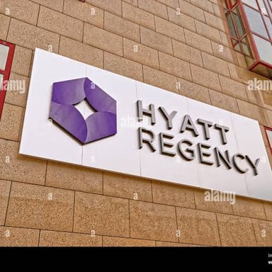 The exterior sign of a Hyatt hotel, identifying the international hotel brand.