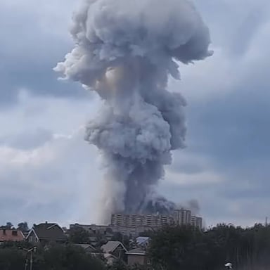A large explosion producing a bright blast and rising smoke
