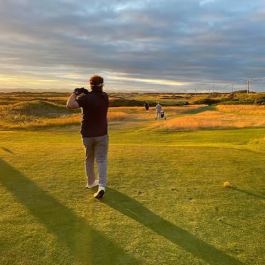 A golfer playing on a links-style golf course