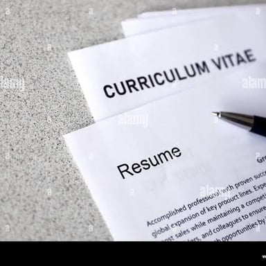 Printed job resumes arranged on a desk.