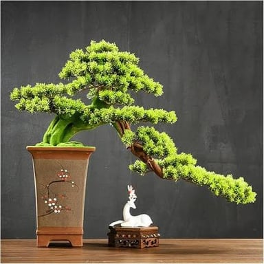 An artificial leafy tree in a pot, used as indoor greenery without watering.