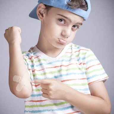 A person reacting to a painful bump while holding an injured arm