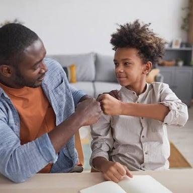 An adult talking warmly with a child.