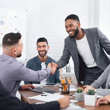 A new employee being welcomed by coworkers at a workplace.