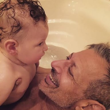 A parent affectionately embracing a child.