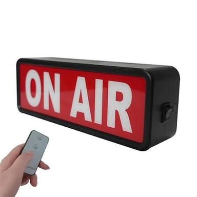 An illuminated ON AIR sign outside a broadcast studio.