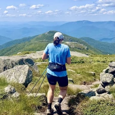 A person climbing upward on a mountain trail.