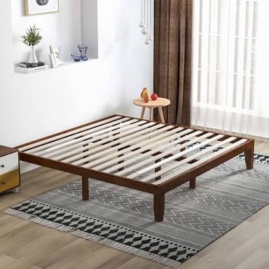Wooden slats supporting a mattress in a bed frame.