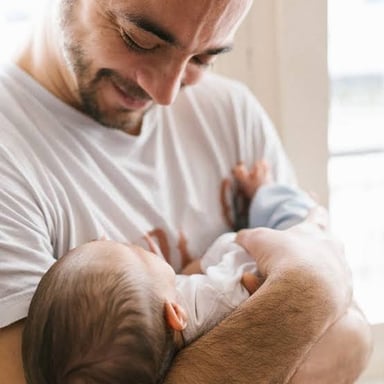 A parent holding a newborn baby.