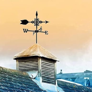 A rooftop weather vane with an arrow that turns to indicate wind direction.