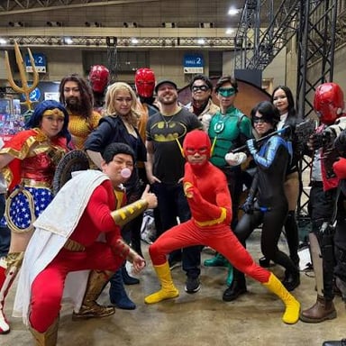 Convention attendees and displays featuring DC Comics superheroes