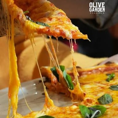 Melted mozzarella stretches in strands from a slice of pizza.