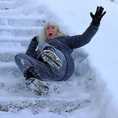 A person losing their footing on an icy path.